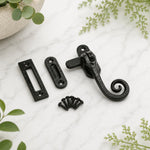 Black cast iron monkey tail window fastener with mortice and hook receivers