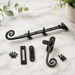 Black cast iron monkey tail window fastener with mortice and hook receivers