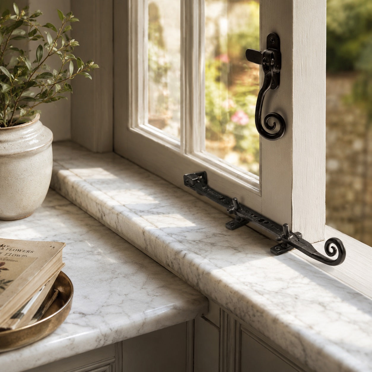 Black monkey tail window stay installed on a timber casement window