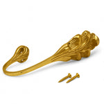 Close-up of antique brass feather leaf curtain tie back finish