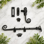 Close-up of black powder-coated cast iron monkey tail window furniture