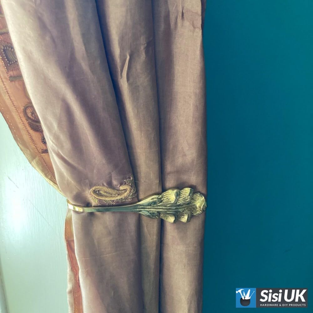 Decorative solid brass curtain tie backs installed with curtains