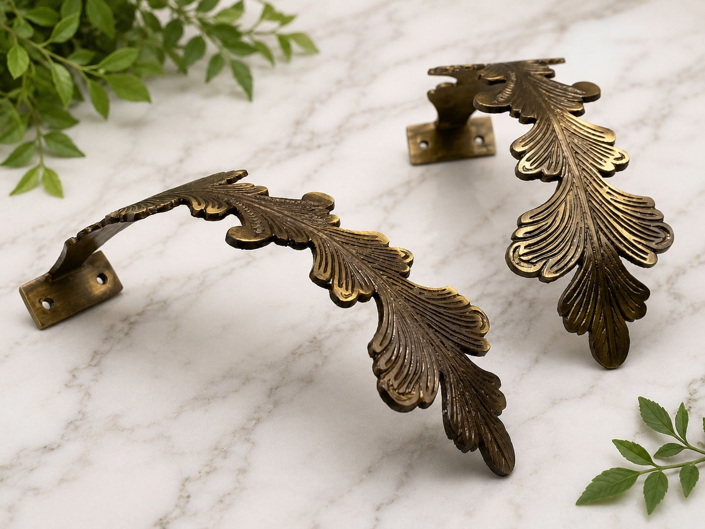 Pair of brass leaf curtain tiebacks with decorative feather design