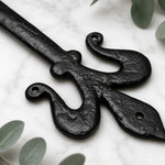 Side profile of black cast iron decorative false door hinge