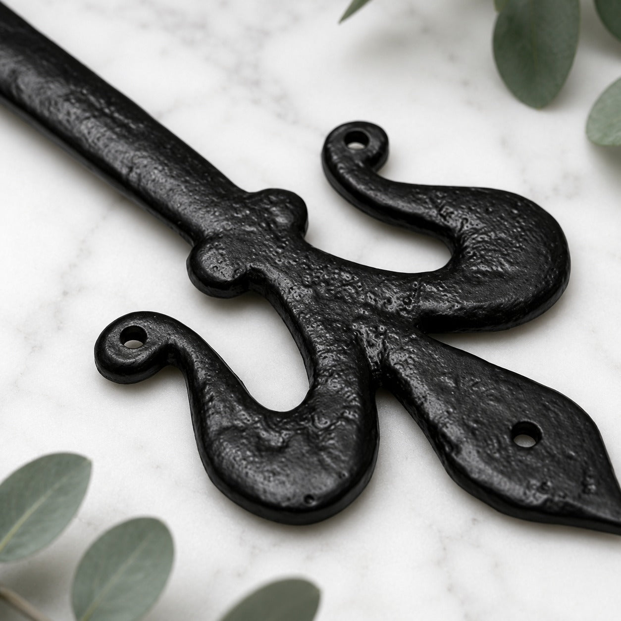 Side profile of black cast iron decorative false door hinge